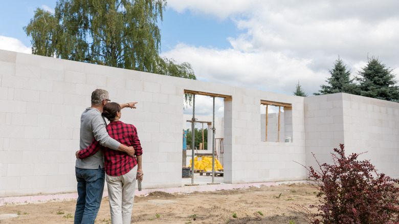 Couple looking at house mid-build 