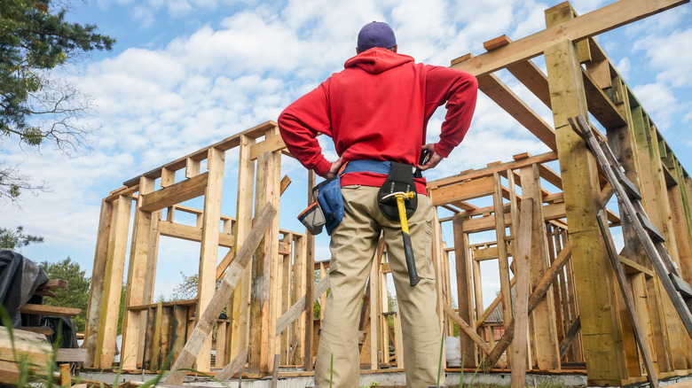 Contractor standing in front of new home being built