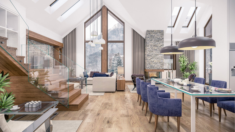 An oversized a-frame window in a living room.