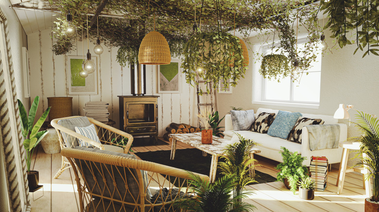 A rustic living room with statement greenery decor on the ceiling and throughout the room.