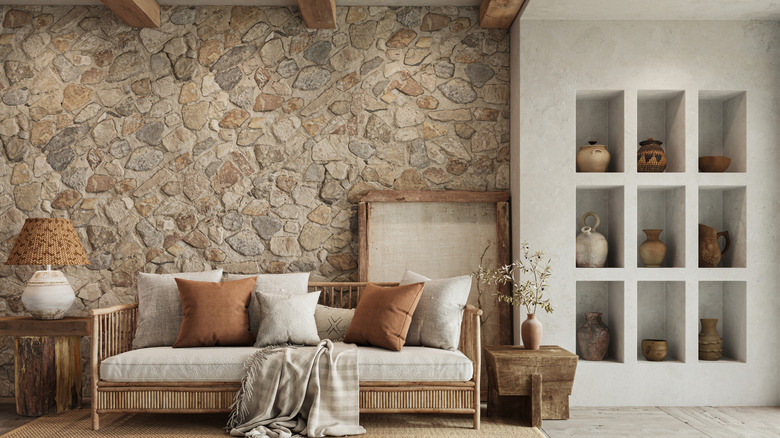 A living room with a rough-hewn stone accent wall.