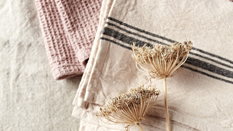 Tea towels on table with dried flowers