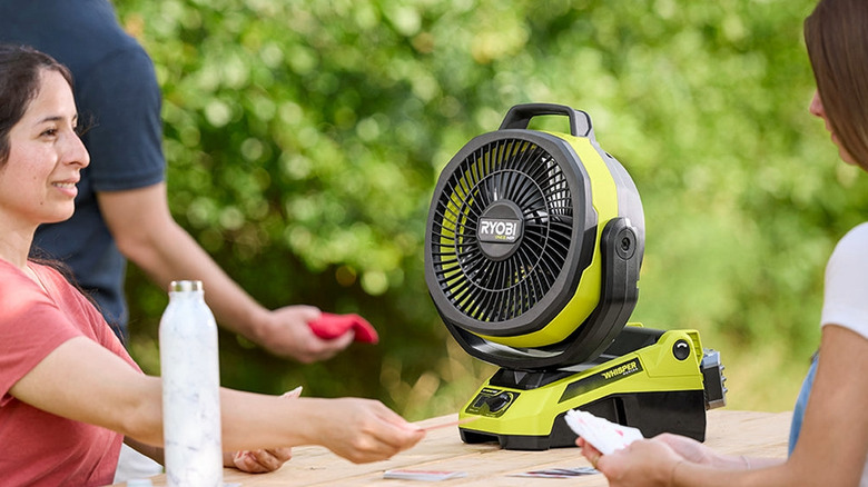 A Ryobi fan sitting on a picnic table
