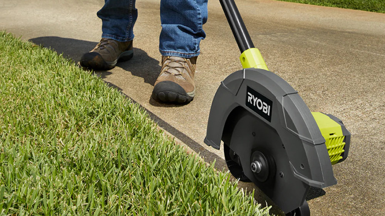 Close-up of a person edging their lawn with Ryobi's 18V One+ Cordless Battery Edger (tool only)