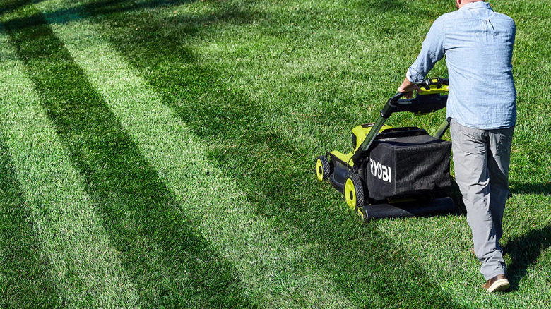 A person striping their lawn with Ryobi's Lawn Striper Kit for 20 and 21-inch mowers
