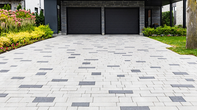 A stylish driveway made with two different colored pavers