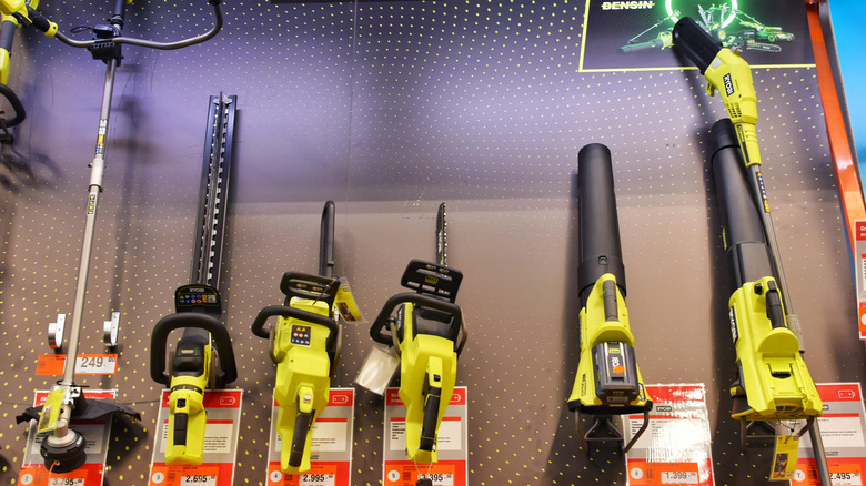 A line-up of Ryobi tools in a retail store