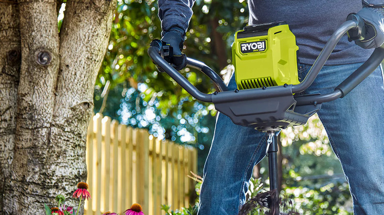A person using Ryobi's 40V 8-inch Earth Auger