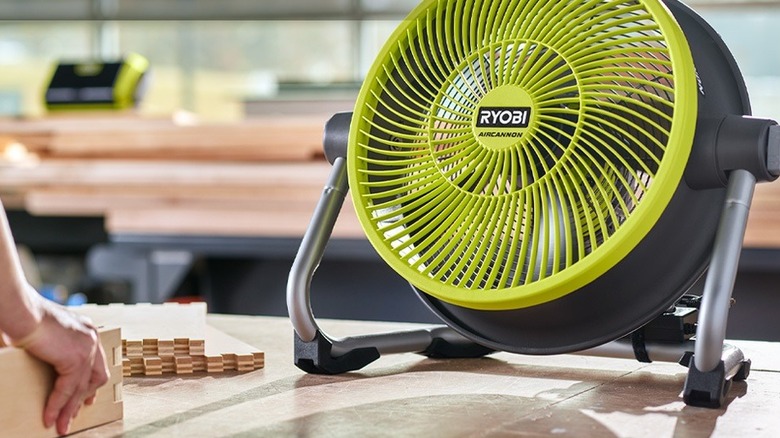 person using Ryobi fan