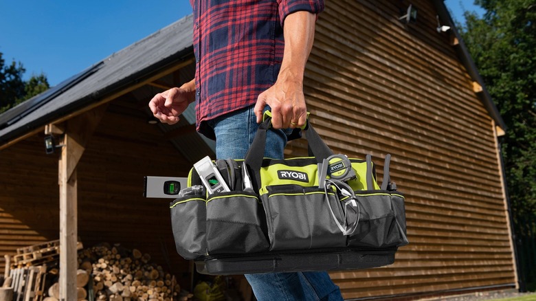 person carrying tool bag