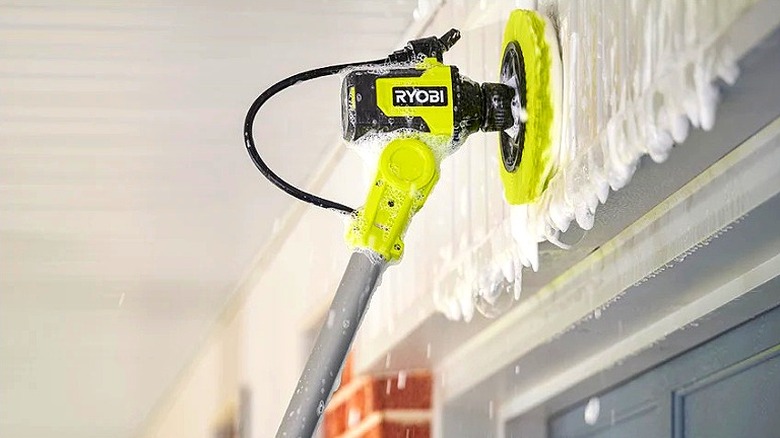 The Ryobi 18V One+ Vortex Soap Dispensing Telescoping Scrubber Kit used to clean exterior siding