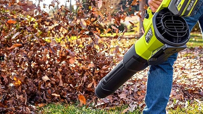 The Ryobi 40V HP Brushless Whisper Series Blower blowing leaves in a yard