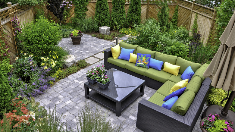 Small garden landscaping with couches and a table