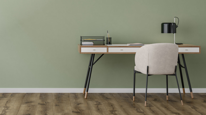 Home office with a sage green wall