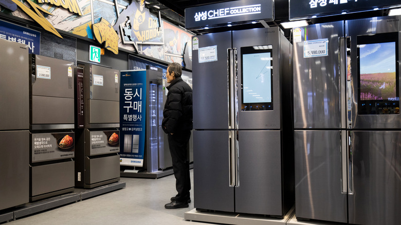 Man observes Samsung refrigerator display
