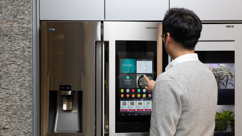 Man using Samsung fridge touchscreen