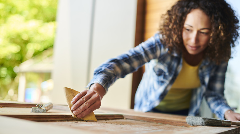 woman sanding wood