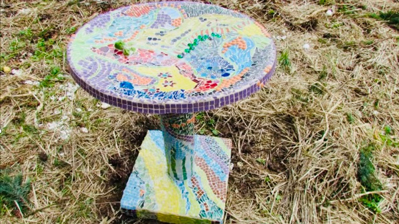Mosaic bird bath made from only the dish portion of a satellite dish with a DIYed stand