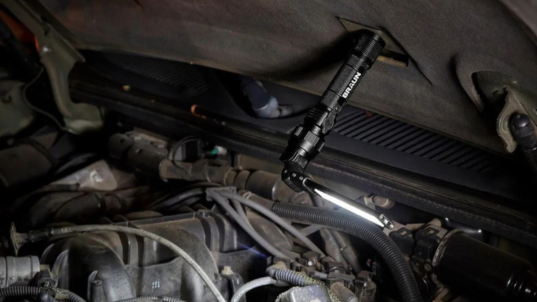 Braun's Handheld Foldable Slim Bar Work Light stuck magnetically to the hood of a car