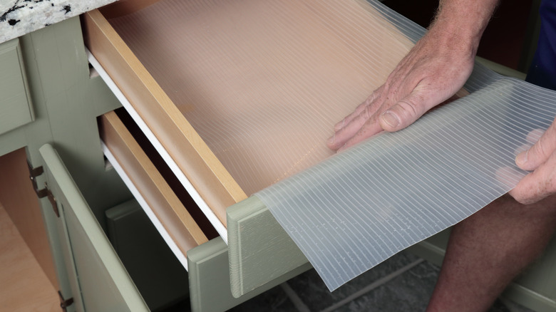 Person lining drawer