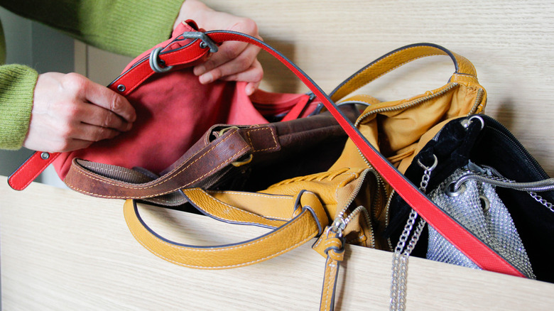 Messy purses stashed in a closet drawer