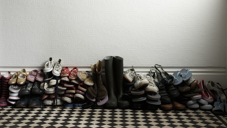Family's shoes piled in hallway