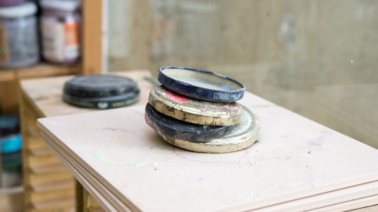 Metal jar lids ready to be cleaned for painting