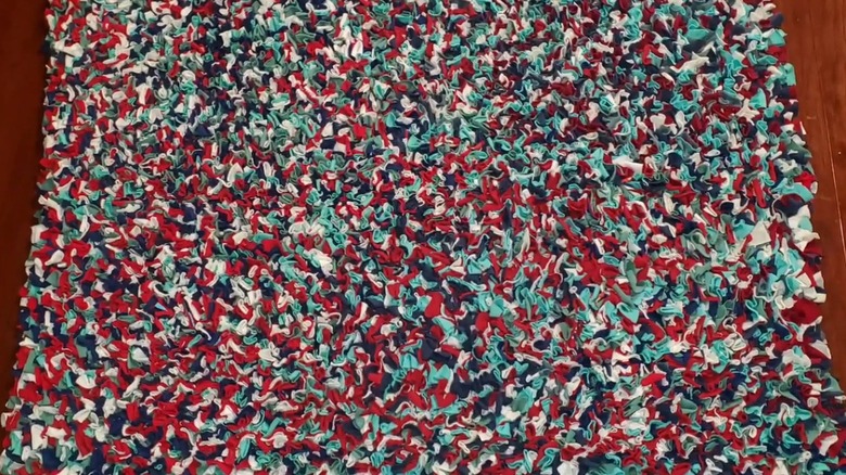 A colorful t-shirt shag rug on a wood table