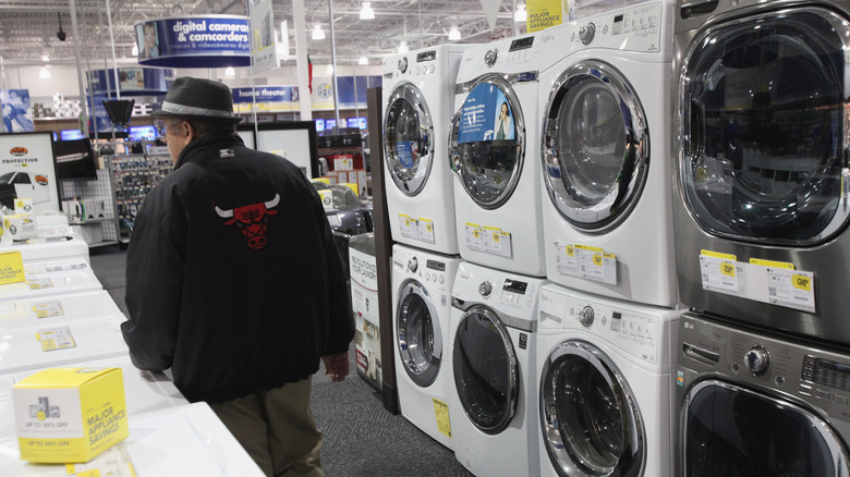 man walking through washer aisle