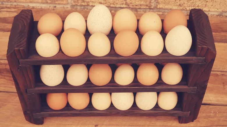 Three dozen eggs in an organizer made from scrap wood