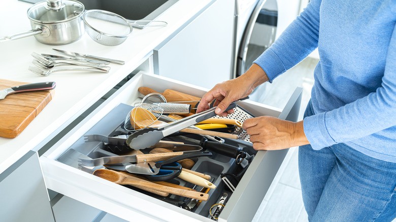 Person sorting kitchen utensils