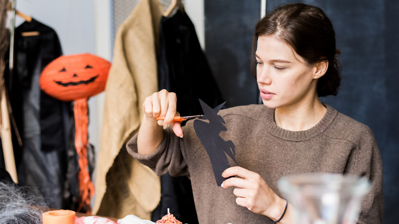 Young woman makes Halloween themed crafts
