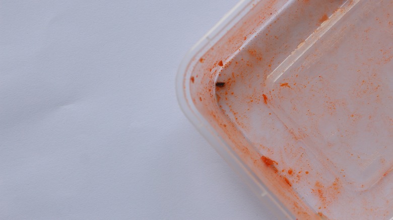 plastic container with red stains