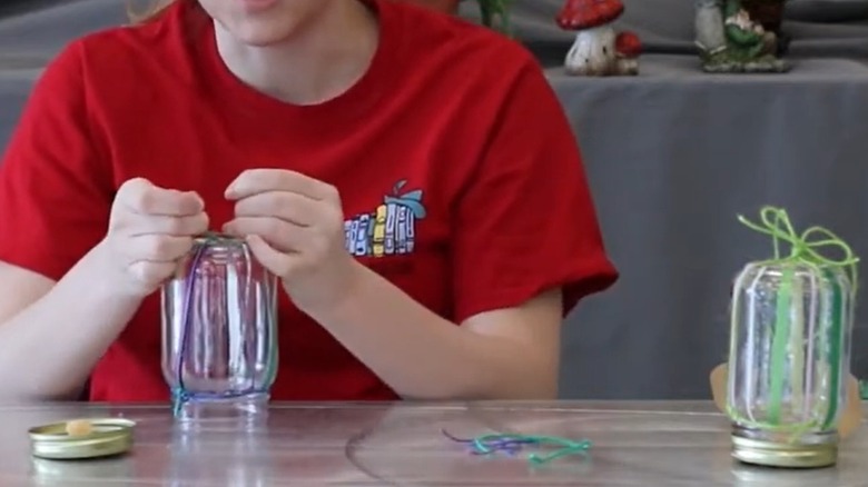 Person making a DIY butterfly feeder