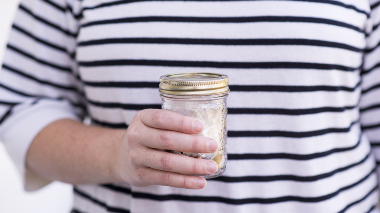 Person holding mason jar