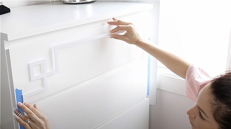 Lady adding overlay on her IKEA Malm dresser