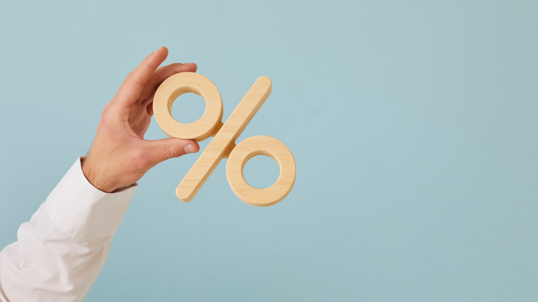 Person holding percentage sign