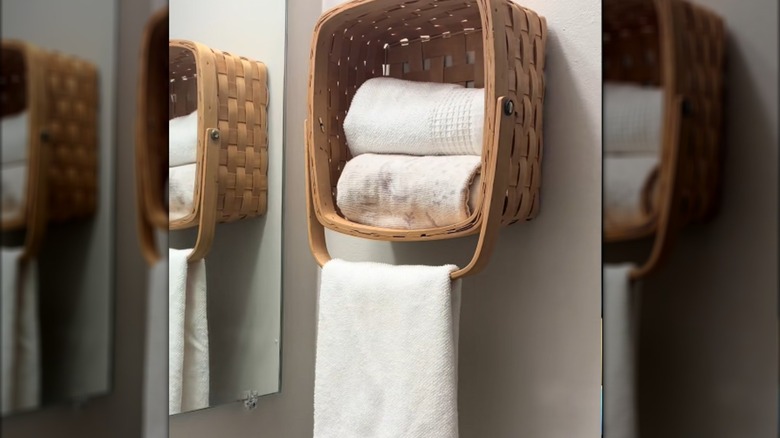 basket hanging on wall as a hand towel rack in bathroom