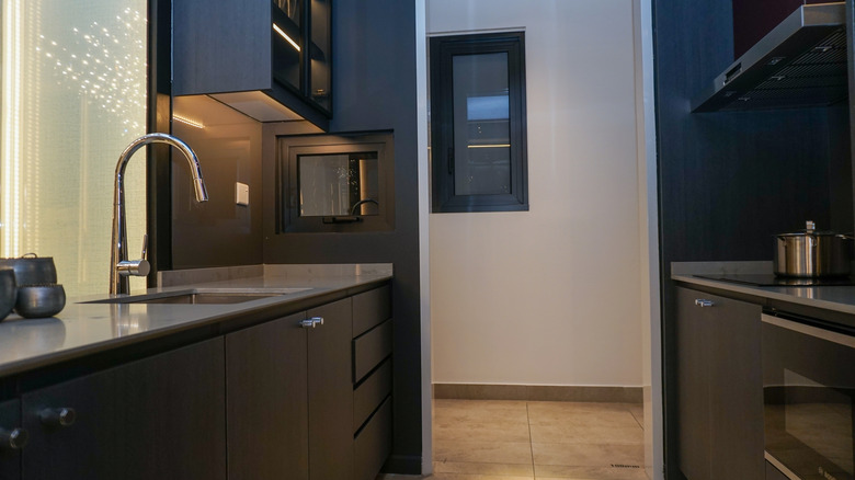 kitchen with dark cabinets and chrome tap