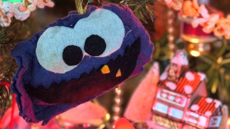 A handmade Cookie Monster ornament on a Christmas tree