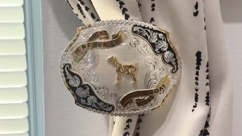Silver Western belt buckle used as curtain tie back