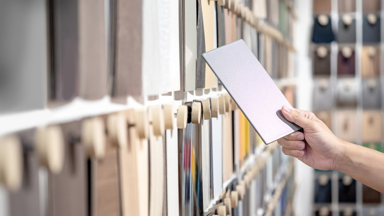 A person shopping for bathroom tiles at a home store
