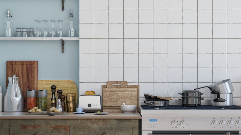 Kitchen with tile and painted backsplash with pots on counter