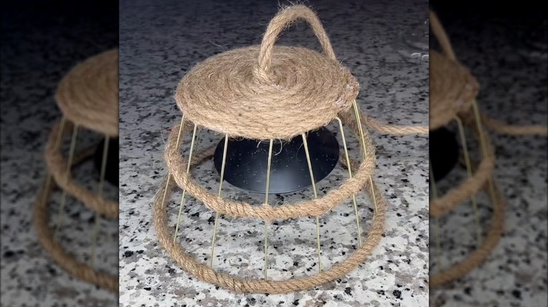 Wire basket wrapped with twine robe to create lampshade.