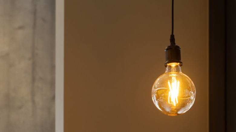 A lightbulb hanging from a ceiling