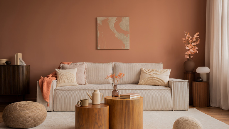 Stylish living room with warm pink walls and accents