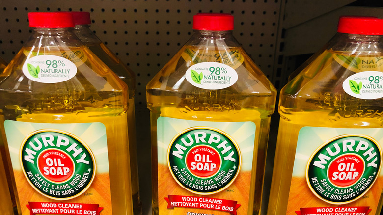 Three bottles of Murphy Oil Soap sitting on a store shelf