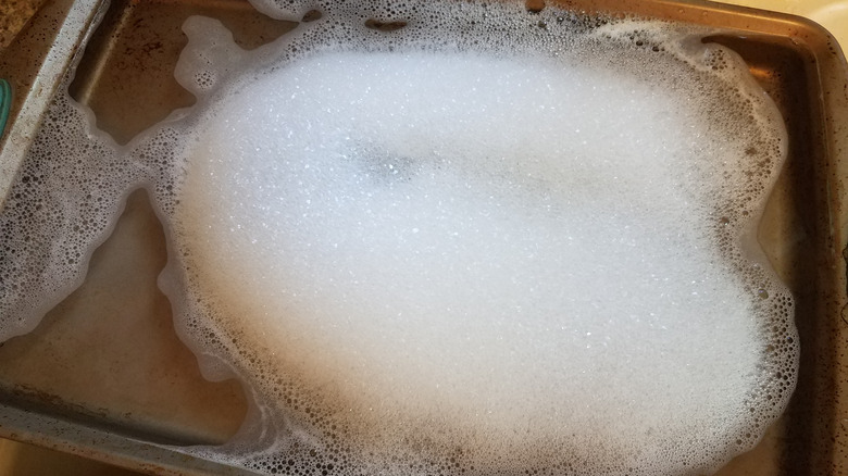 Baking sheet in soapy water