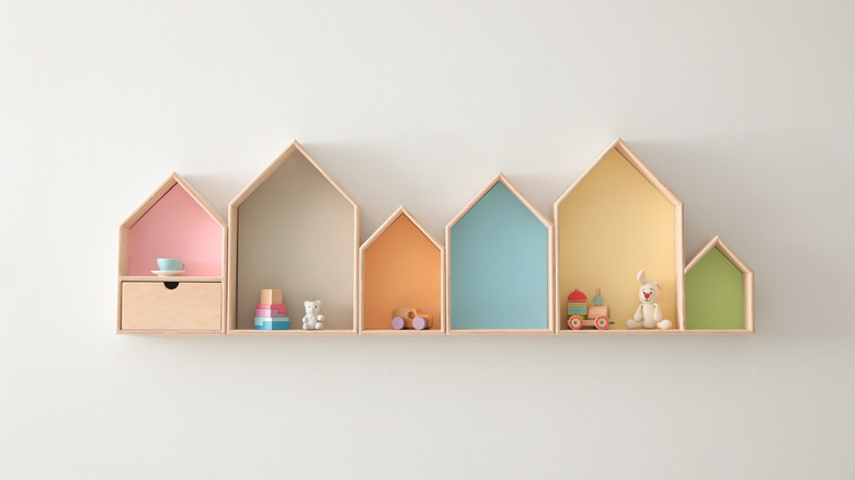 House-shaped shelves on a white wall