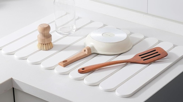 A photo of a white foldable dish drying rack from Amazon in use